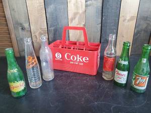 lot 27 image: Collectible Plastic Coke Crate with Handle and Various Vintage Soda Bottles