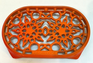 lot 10 image: Le Creuset Orange Enameled Cast Iron Trivet Sunburst Pattern