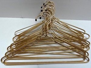 lot 104 image: Set of 10 Gold Metal Clothes Hangers