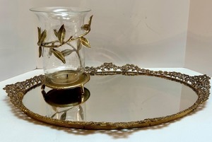 lot 67 image: Vintage Ornate Oval Vanity Mirror Tray with Gold Floral Rim and Glass Hurricane Candle Holder