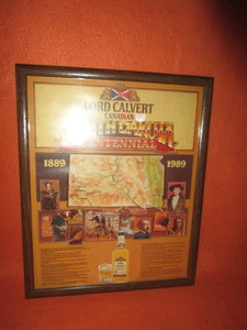lot 51 image: Lord Calvert South Dakota Centennial Framed Poster 17x22