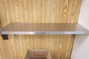 lot 52 image: Stainless Steel Shelf 10x32 (screwed to wall)