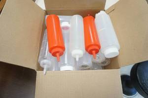 lot 68 image: Egg Box Full of Clear Plastic Squeeze Bottles (10oz and larger)