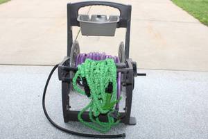 lot 296 image: Rolling Hose Reel Cart with Purple and Green Garden Hoses