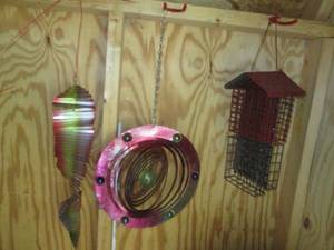 lot 223 image: Colorful wind spinners and suet fee...
