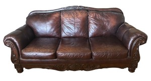 lot 22R image: Elegant Leather Sofa with Carved Wood Accents