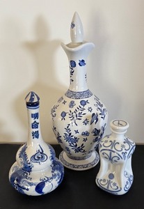 lot 52 image: Set of 3 Blue and White Porcelain Decanters by Coalport, HPF, and Alton Costa