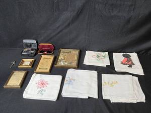 lot 89 image: Vintage Embroidered Linens, Framed Sayings, Retro Sunglasses, Sewing Kit, and Sword Pin Collection