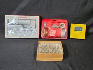 lot 93 image: Vintage Baking and Pastry Tool Collection with Cookie Presses, Decorating Tips, and Swedish Sandbakelser Forms