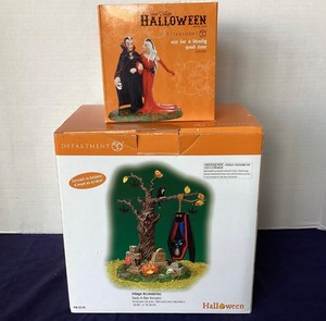 lot 22 image: Pair of Dept. 56 Halloween Rock-A-Bye Vampire and Out For a Good Time