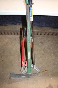 lot 63 image: Group of Hand Tools Including Pickaxe, Bolt Cutters, and Post Driver
