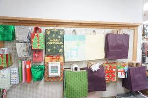 lot 179 image: Wall of Gift Bags, Tissue Paper, and Wrapping Paper