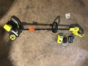 lot 56 image: RYOBI ONE 18V 13 in. Cordless Battery String TrimmerEdger with 4.0 Ah Battery and Charger Used Good  Customer Returns See Pictures