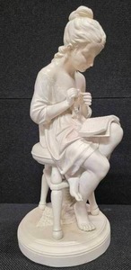 lot 84 image: Sculpture of a woman sitting on a stool and reading a book