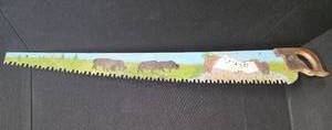 lot 78 image: 53 Hand Saw with Mt. Rushmore mural painted on it.