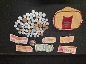 lot 71 image: Money bag made in Hong Kong, with a collection of (mostly) foreign coins and bills