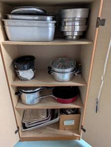 lot 569 image: Tall Oak-Look Kitchen Storage Cabinet with Assorted Cookware and Bakeware