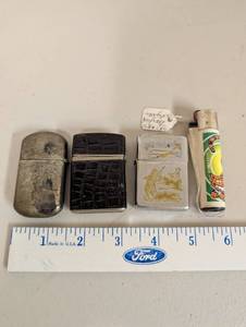 lot 618 image: Group of 4 Vintage and Modern Lighters Including Camel, Croc Pattern, Hunter Design, and Cat Motif