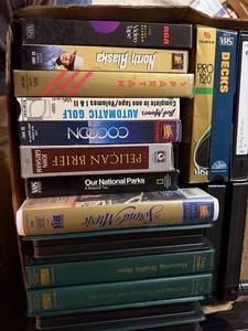 lot 751 image: Box of VHS Tapes and Golf Books Including The Sound of Music, North to Alaska, Mastering Trouble Shots