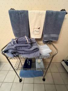 lot 17 image: Bathroom Towel Set with Decorative Accessories and Embroidered Hand Towels on Portable Cart