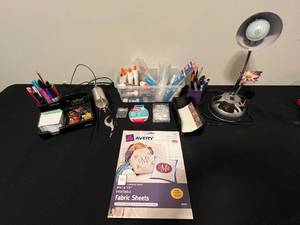 lot 20 image: Office and Craft Supply Lot with Desk Lamp, Stationery, Pens, and Glue in Clear Tote