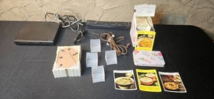 lot 195 image: Capello DVDCD Player with Cables, Power Strip, and Vintage Recipe Card Box Set