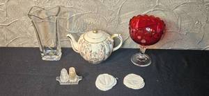 lot 268 image: Vintage Decor Lot Clear Glass Vase, Red Glass Compote, Porcelain Teapot, Salt & Pepper, and Linen Coasters