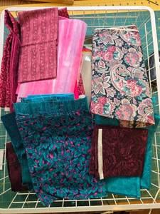 lot 372 image: Assorted Lot of Quilting Fabric Remnants in Pink, Blue, and Teal Prints