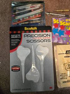 lot 479 image: Assorted Office and School Supplies Collection with Scissors, Pens, Laminating Sheets, and Awards