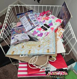 lot 486 image: Assorted Gift Bags, Shredded Paper Filler, and Holiday Wrapping Lot