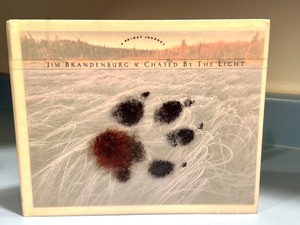 lot 194 image: Chased By The Light by Jim Brandenburg Hardcover Photo Book