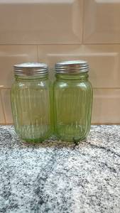 lot 7 image: Pair of Vintage Ribbed Vaseline Uranium Glass Shakers with Metal Lids