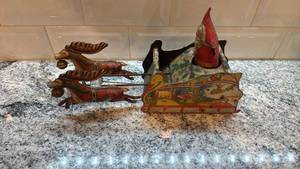lot 61 image: Antique Strauss Santee Claus Mechanical Tin Toy Sleigh with Reindeer