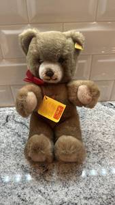 lot 84 image: Steiff 10-Inch Plush Teddy Bear with Red Bow and Tag