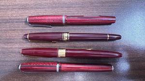 lot 157 image: Set of 4 Vintage Red Fountain Pens with Gold and Silver Trim