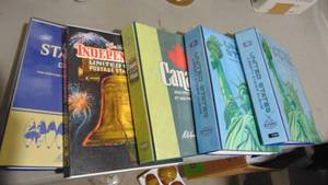 lot 51A image: 5- Stamp Books, Independence US 12 Full, Stateman Deluxe Album 12 Full, Canada 14 Full, United States Liberty Stamp almost Full and United States Liberty Stamps Mostly Empty