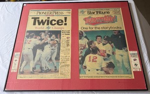lot 32 image: 1991 World Series Framed Piece with Game 1 and Game 2 Tickets and Star Tribune  Pioneer Press Newspapers - Minnesota Twins