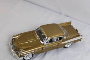 lot 120 image: Gold Diecast Model Car with Opening Doors and Detailed Undercarriage