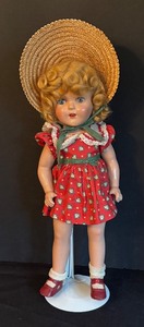 lot 43 image: Vintage Composition Doll with Straw Hat and Red Dress