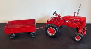 lot 55 image: Vintage Ertl McCormick Deering Farmall Tractor with Wagon