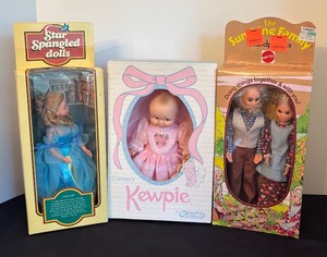 lot 85 image: New Kewpie Doll, Star Spangled Colonial Girl Doll, and Sunshine Family Grandparents Dolls Set
