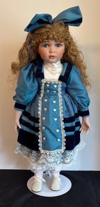 lot 160 image: Vintage Porcelain Doll with Blue Dress and Bow