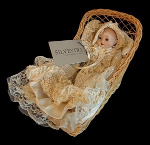 lot 303 image: Vintage Silvestri Dollcrafter Classics Baby Doll with Lace Dress and Wicker Bassinet