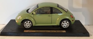 lot 692H image: K - Maisto Volkswagen New Beetle Diecast Model Car on Display Base