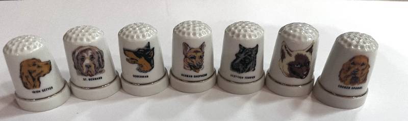 lot 31 image: Set of 7 Dog Themed Thimbles