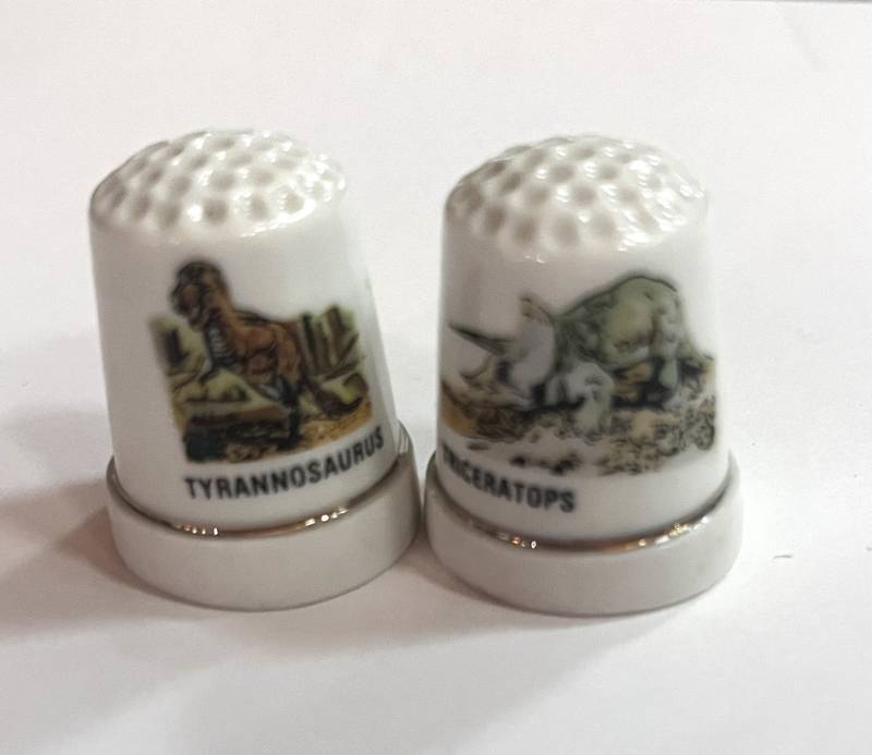 lot 39 image: Two Dinosaur Thimbles. Tyrannosaurus and Triceratops