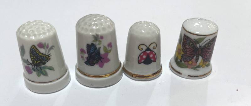 lot 49 image: Set of 4 Ceramic Butterfly Thimbles