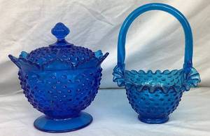 lot 43 image: Pair of 2 Blue Vintage Fenton Glassware Pieces - Blue Hobnail Candy Bowl with Lid (6.5) and Colonial Blue Hobnail Basket (8)
