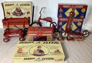 lot 91 image: Radio Flyer Bundle- Includes The Little Wood Wagon - Model 6, The Tricycle - No. 553, The Scooter - No 557, The Little Wood Sled - No 551, The 80th Anniv. Streak-o-Lite - Model 1934, 3 Radio Flyer Ornaments