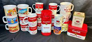 lot 146 image: Assorted Campbells Collectables- Includes Electric can Opener, Tins, Insulated Travel Soup Mug, Oversized Mugs, and Coffee Cups - 22 Pieces Total